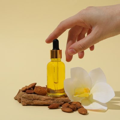Skin care and body care concept - almonds, almond oil